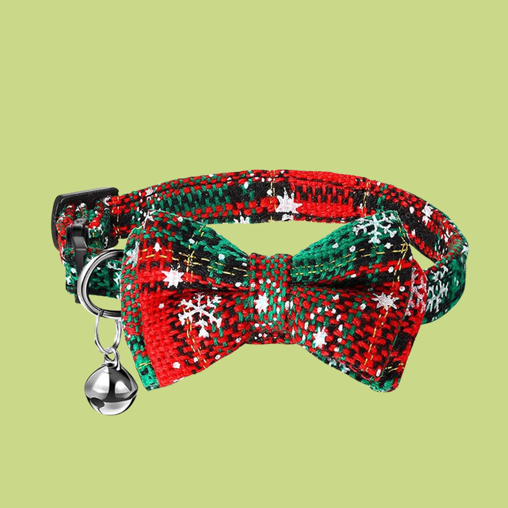 Red and green plaid bow tie with snowflakes on a light green background