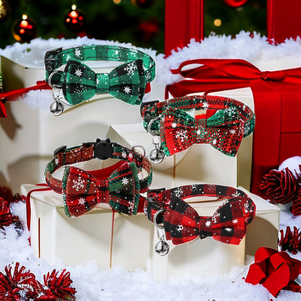 Set of festive dog collars with bow ties on a decorative stand with Christmas decorations.
