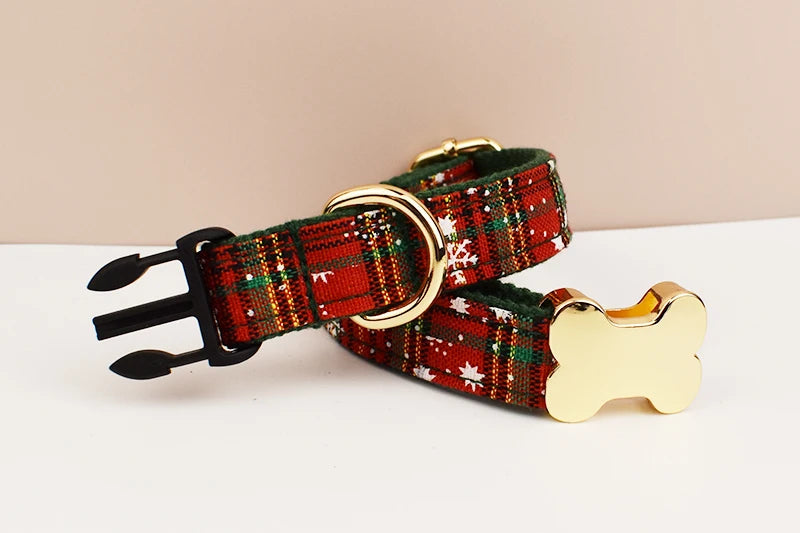 Plaid dog collar with gold bone-shaped tag on a beige background