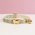 Dog collar with floral pattern and gold hardware on a pink background